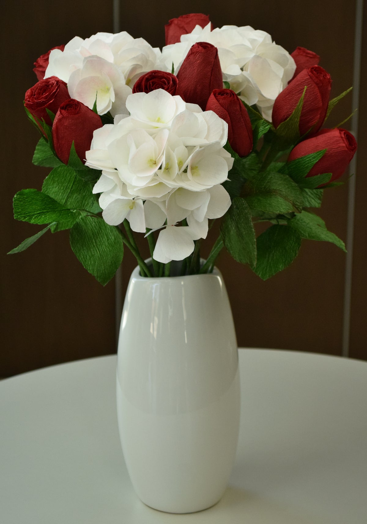 Twelve red hybrid roses and 3 white hydrangeas